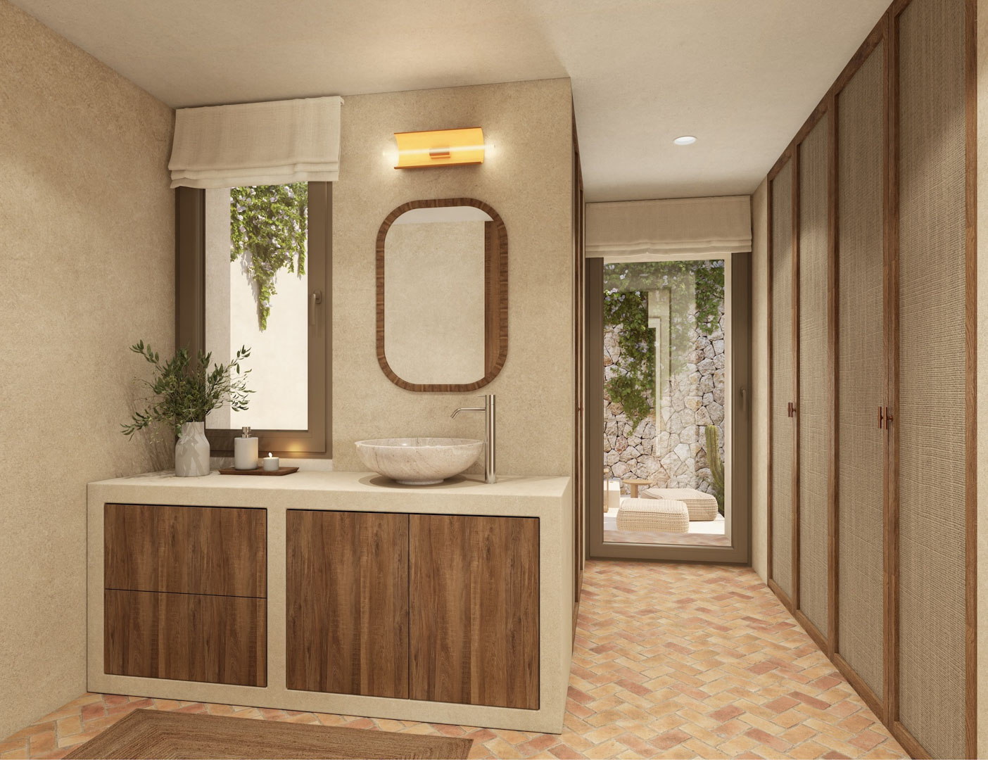 Badezimmer mit Steinwaschbecken, Holzschränken und Terrakottaboden im Fischgrätmuster. Einbauschränke mit Textilfronten und Zugang zu einem privaten Innenhof mit Steinmauer.