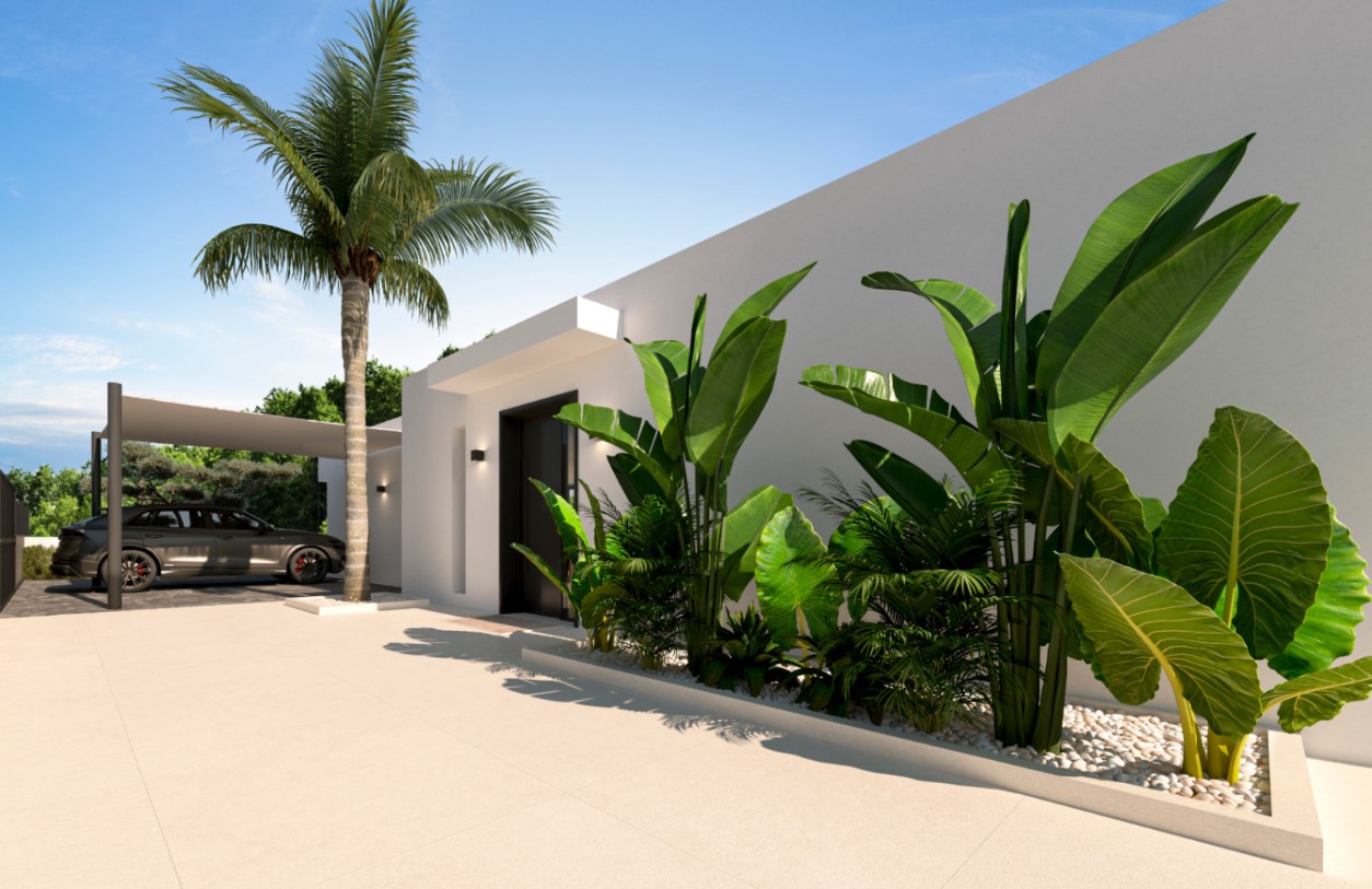 Haupteingang im minimalistischen Design mit dunkler Tür, weißen Steingärten mit tropischen Pflanzen und einem überdachten Carport neben einer Palme.