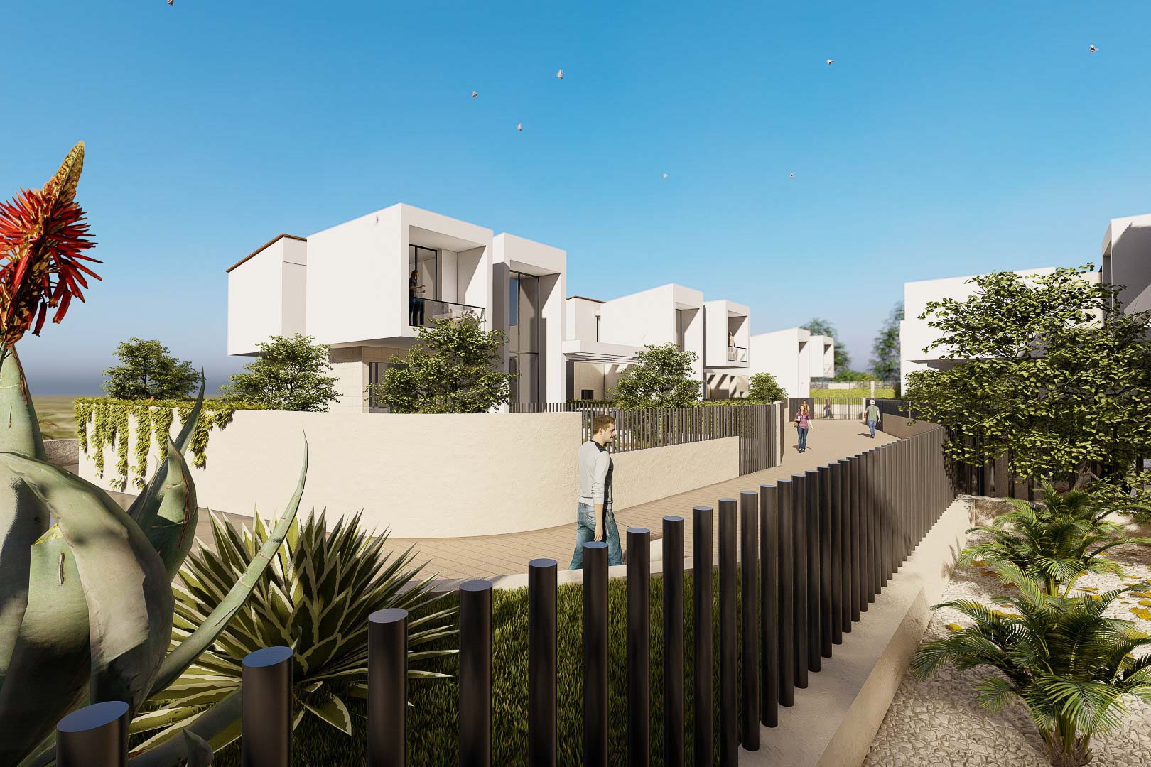 Außenfassade weißer kubischer Villen mit Glasbalkonen, eingebettet in eine Anlage mit Umfassungsmauern und mediterraner Vegetation.