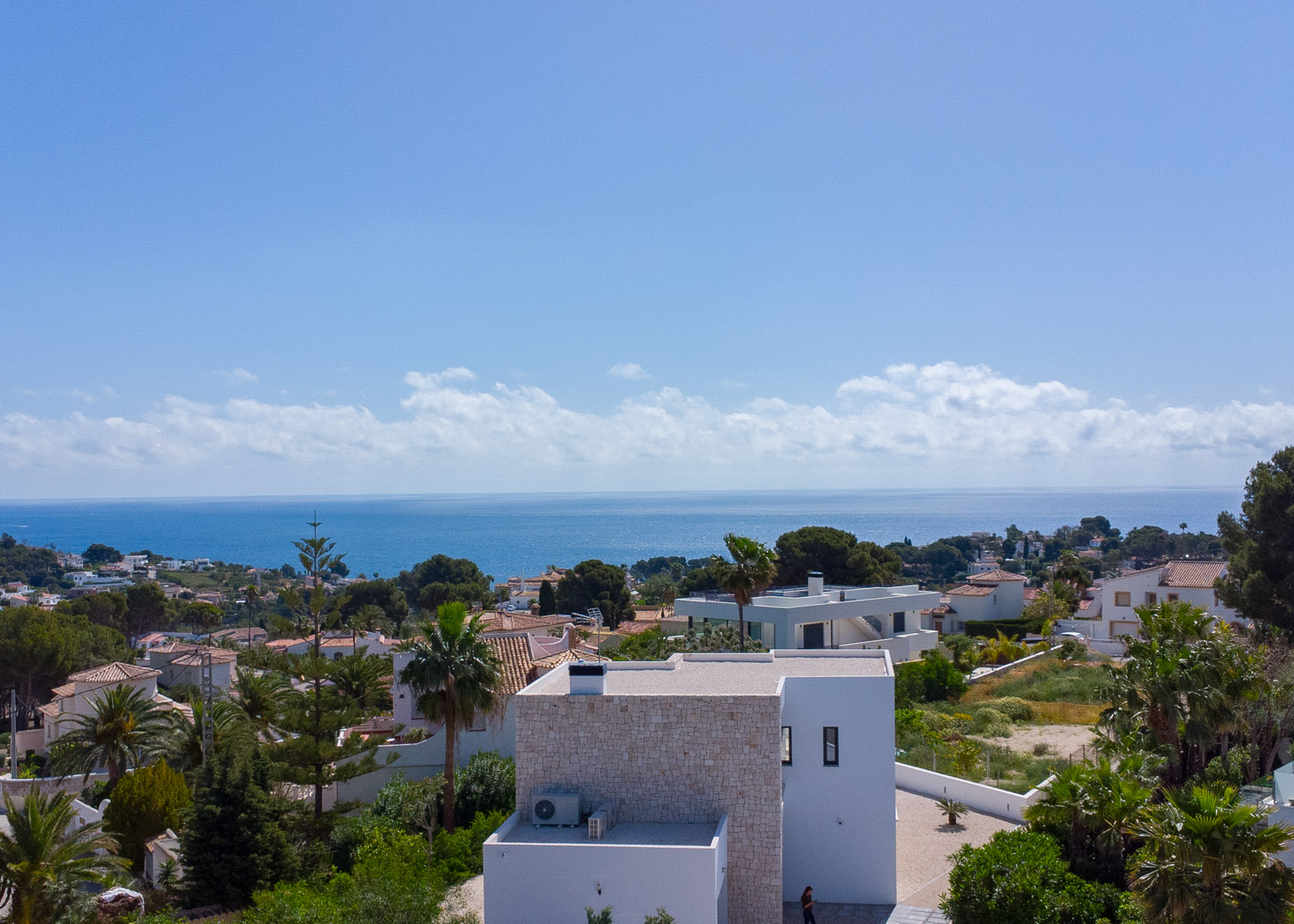 Erhöhte Ansicht der modernen Architektur mit Natursteinakzenten, Panoramablick auf das Mittelmeer und die grüne Umgebung von Benissa.