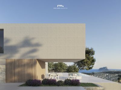 Außenansicht der Villa mit heller Backsteinfassade und Terrasse mit Meerblick.
