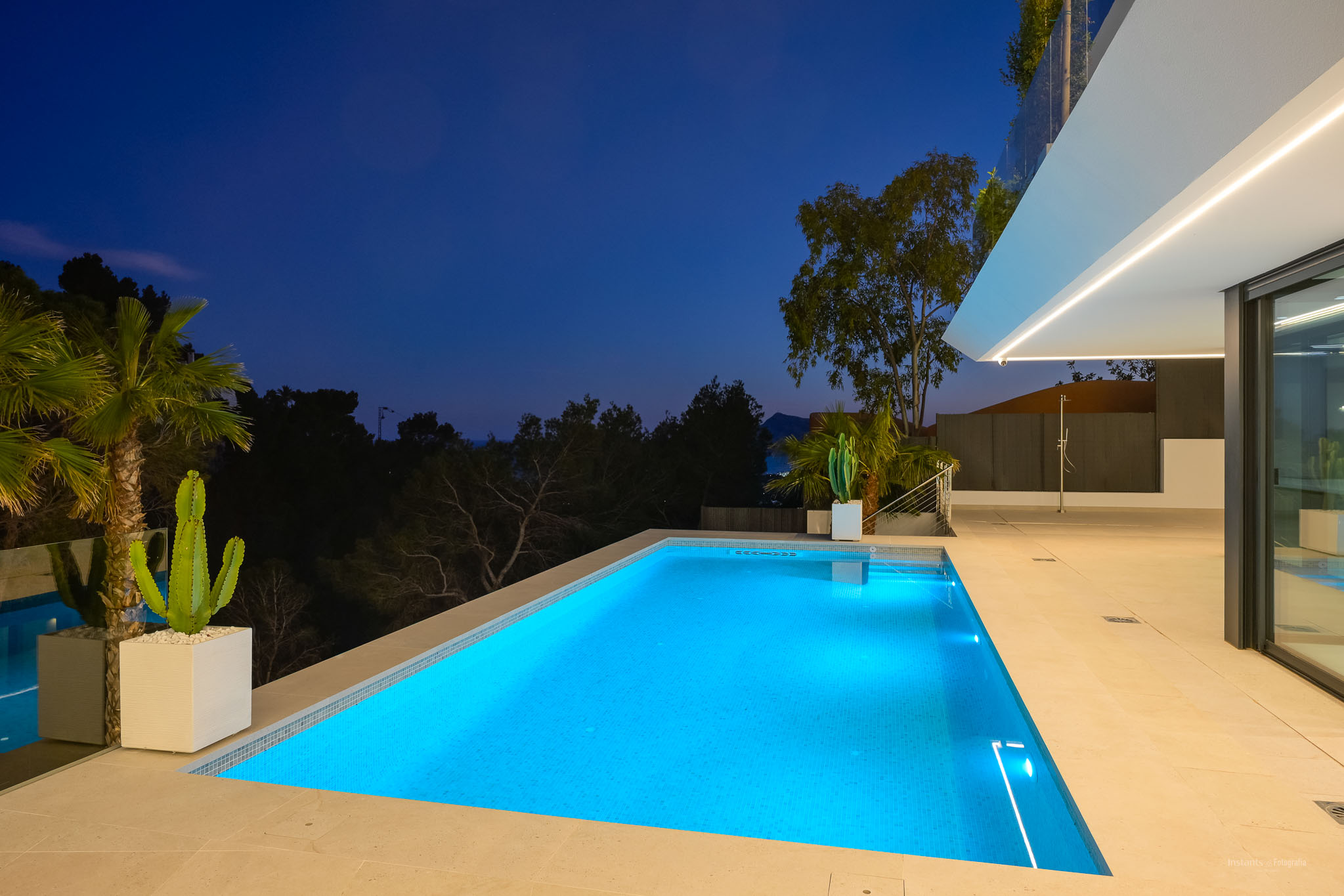 Beheizter Gegenstrom-Pool und Außen-Spa, umgeben von einem mediterranen Garten mit Panoramablick auf das Meer.