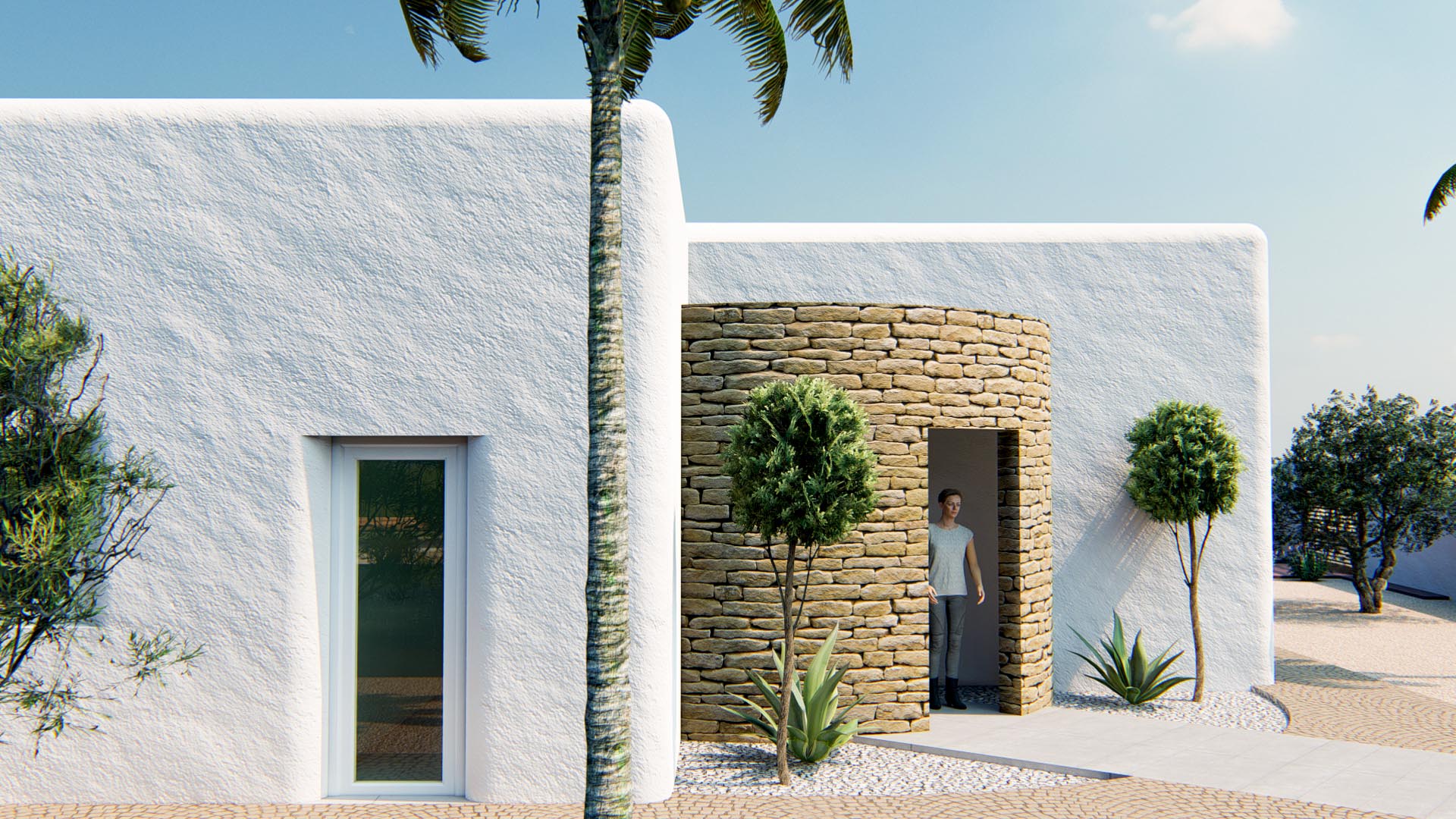 Außenansicht im ibizenkischen Stil mit weiß strukturierten Wänden und einem zylindrischen Eingang aus Naturstein, umgeben von mediterraner Bepflanzung.