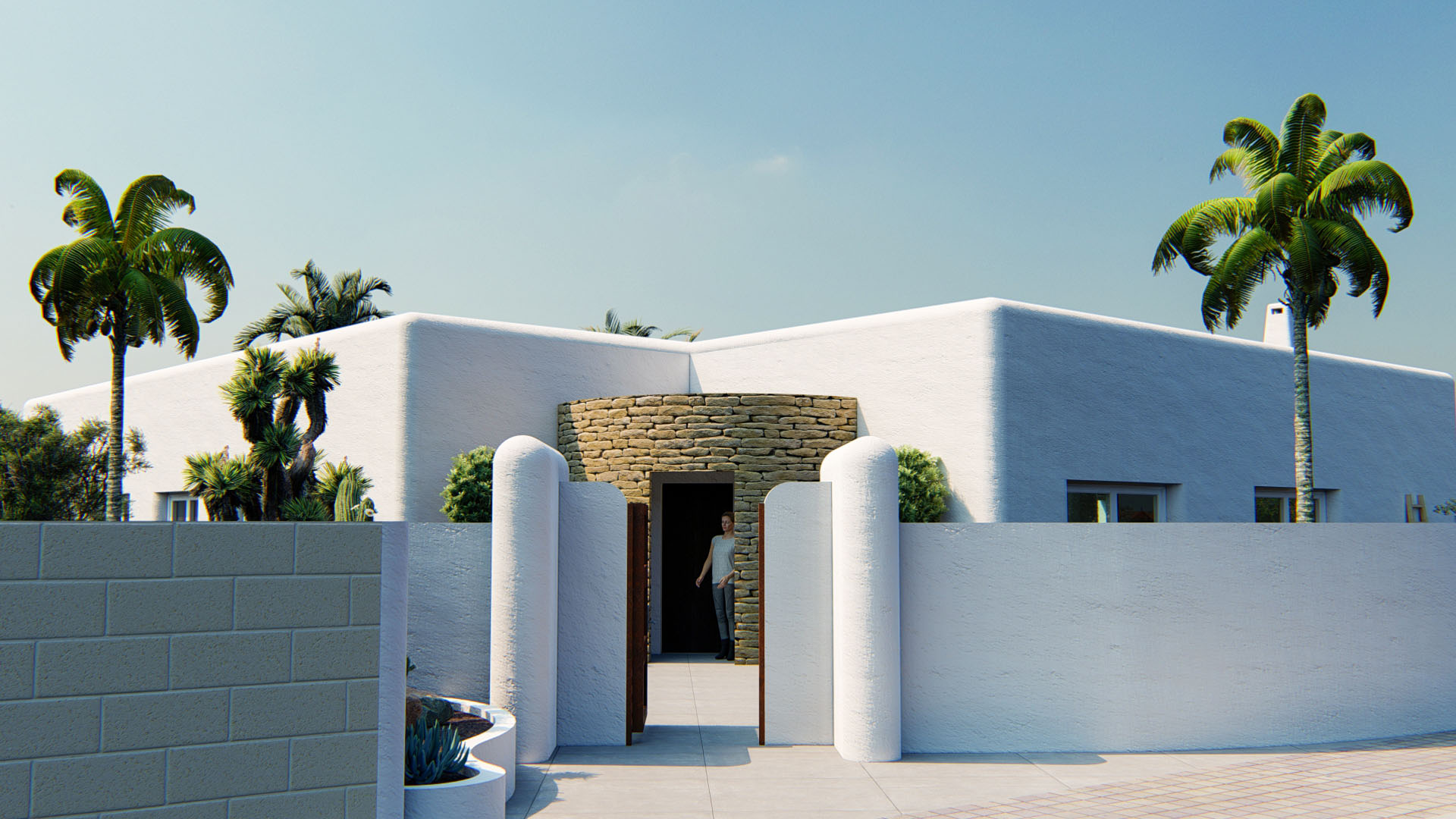 Außenfassade im ibizenkischen Stil mit abgerundeten weißen Wänden und einem durch eine Natursteinmauer betonten Eingangsbereich.
