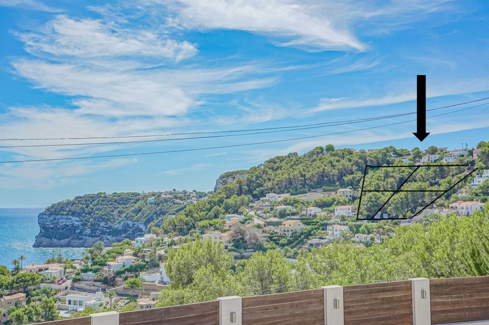 Erhöhter Panoramablick auf die markierten Baugrundstücke am bewaldeten Hang mit Blick auf das Mittelmeer und die markante Küstenlinie von Jávea.
