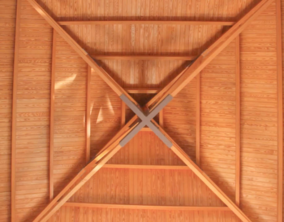 Detailansicht der hochwertigen Holzdecke mit pyramidenförmiger Struktur und zentralen Kreuzbalken, die handwerkliche Präzision und Wärme ausstrahlt.