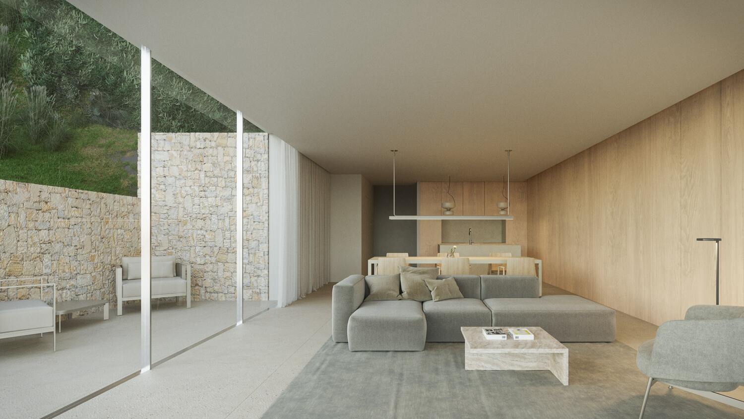 Offener Wohnbereich mit grauem Ecksofa, hellen Holzpaneelen und bodentiefen Glasfronten, die zu einem Außenbereich mit Natursteinmauer führen.