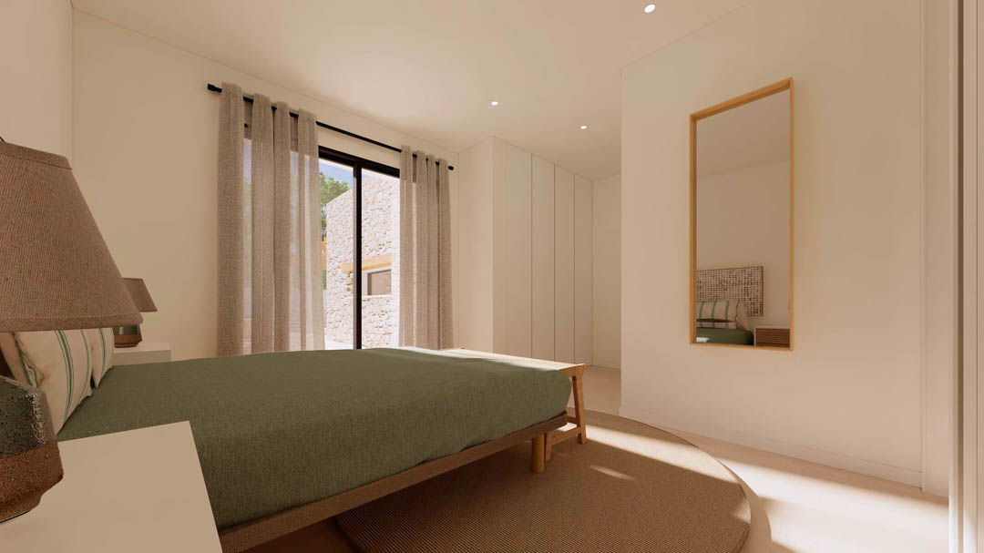 Schlafzimmer im Ibiza-Stil mit Einbauschränken, Holzbett und bodentiefen Fenstern, die den Blick auf eine charakteristische Natursteinmauer freigeben.