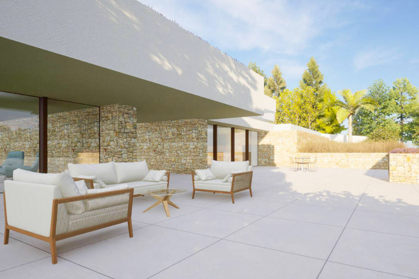 Außenbereich mit modernen Loungemöbeln, Natursteinwänden und großen Glasfronten, die einen nahtlosen Übergang zum Garten schaffen.