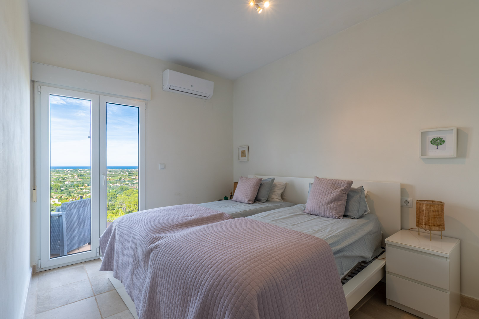 Helles Schlafzimmer mit direktem Terrassenzugang, Klimaanlage und Panoramablick auf das Meer und die umliegende Natur von La Sella.