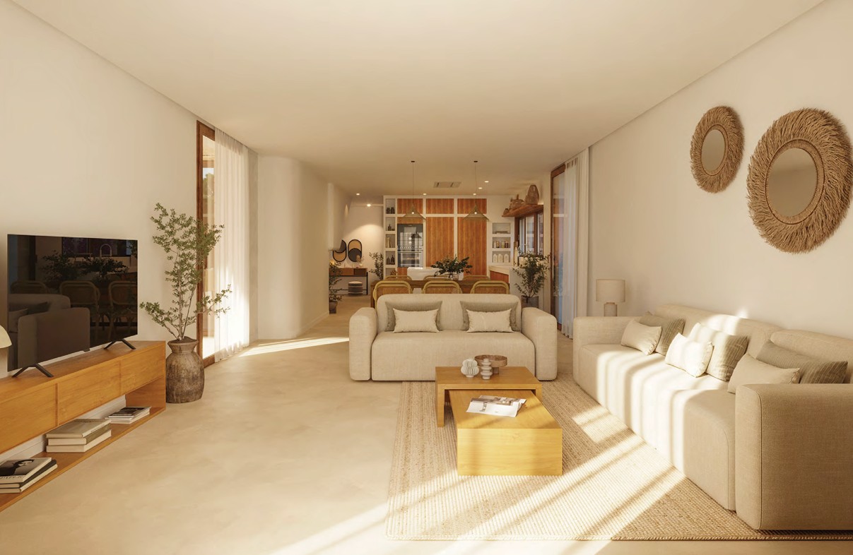 Helles Wohnzimmer mit beigen Sofas, Holztisch und natürlicher Deko.