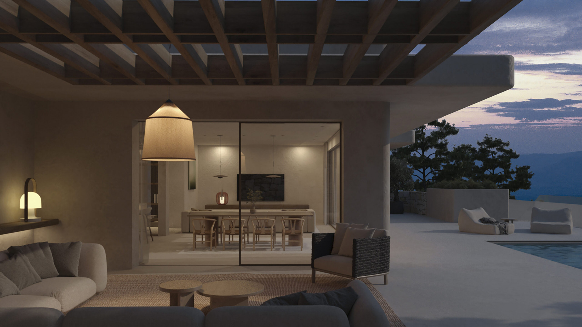 Einladender Außenwohnbereich unter einer Holzpergola mit modernen Sofas und Hängelampe, verbunden mit einem eleganten Essbereich und Bergblick bei Dämmerung.