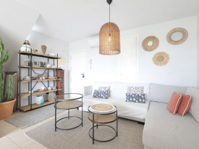 Helles Wohnzimmer mit Holzregal, modularem Sofa und Designer-Beistelltischen.