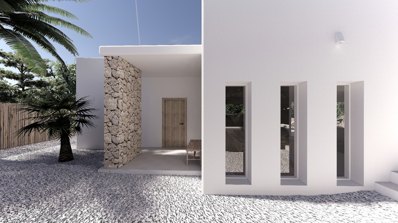 Haupteingang mit weißer Fassade, Natursteinwand und vertikalen Fensterschlitzen. Weißer Kies und mediterrane Bepflanzung prägen den minimalistischen Zugangsbereich.