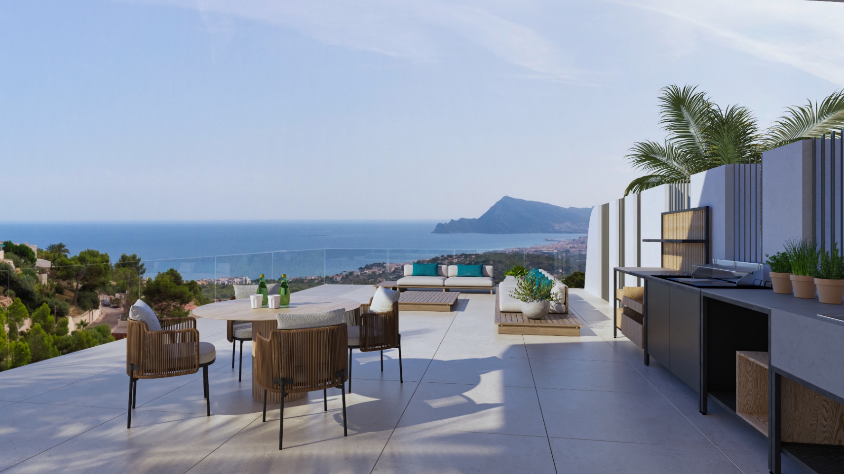 Außen-Terrasse mit Sommerküche, Essbereich und Lounge-Möbeln. Sie bietet einen Panoramablick auf das Mittelmeer und die Küste von Altea durch eine rahmenlose Glasbrüstung.