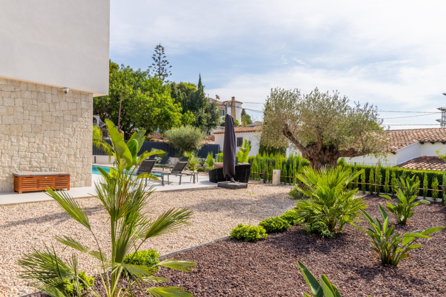 Mediterraner Garten mit Kies, Pool und Sonnenliegen in La Fustera, Benissa.