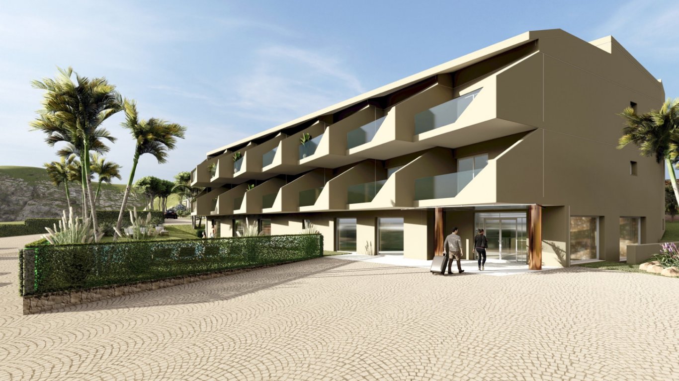 Außenfassade des Boutique-Hotels mit privaten Glasbalkonen, verglastem Haupteingang und gepflastertem Vorplatz, umgeben von mediterraner Bepflanzung.
