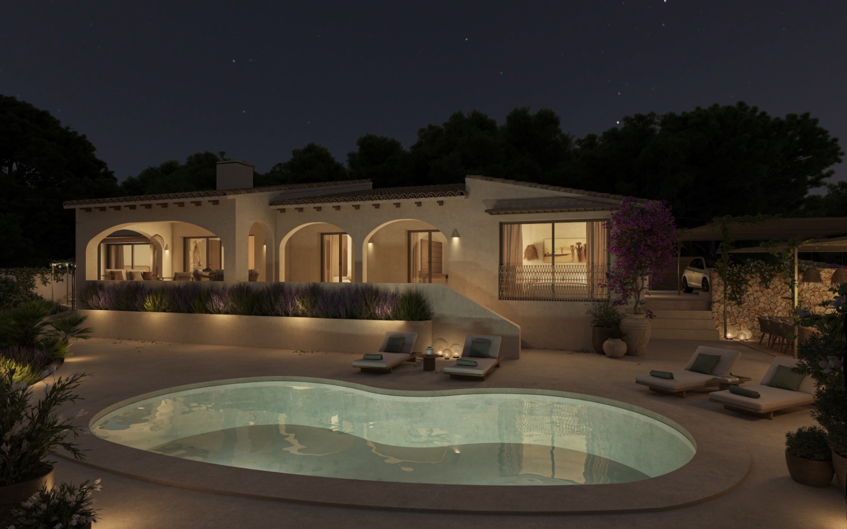 Nachtansicht der Villa mit organisch geformtem Pool, beleuchteten Rundbogen-Veranden und weitläufigen Terrassen mit Sonnenliegen in mediterraner Gartenanlage.