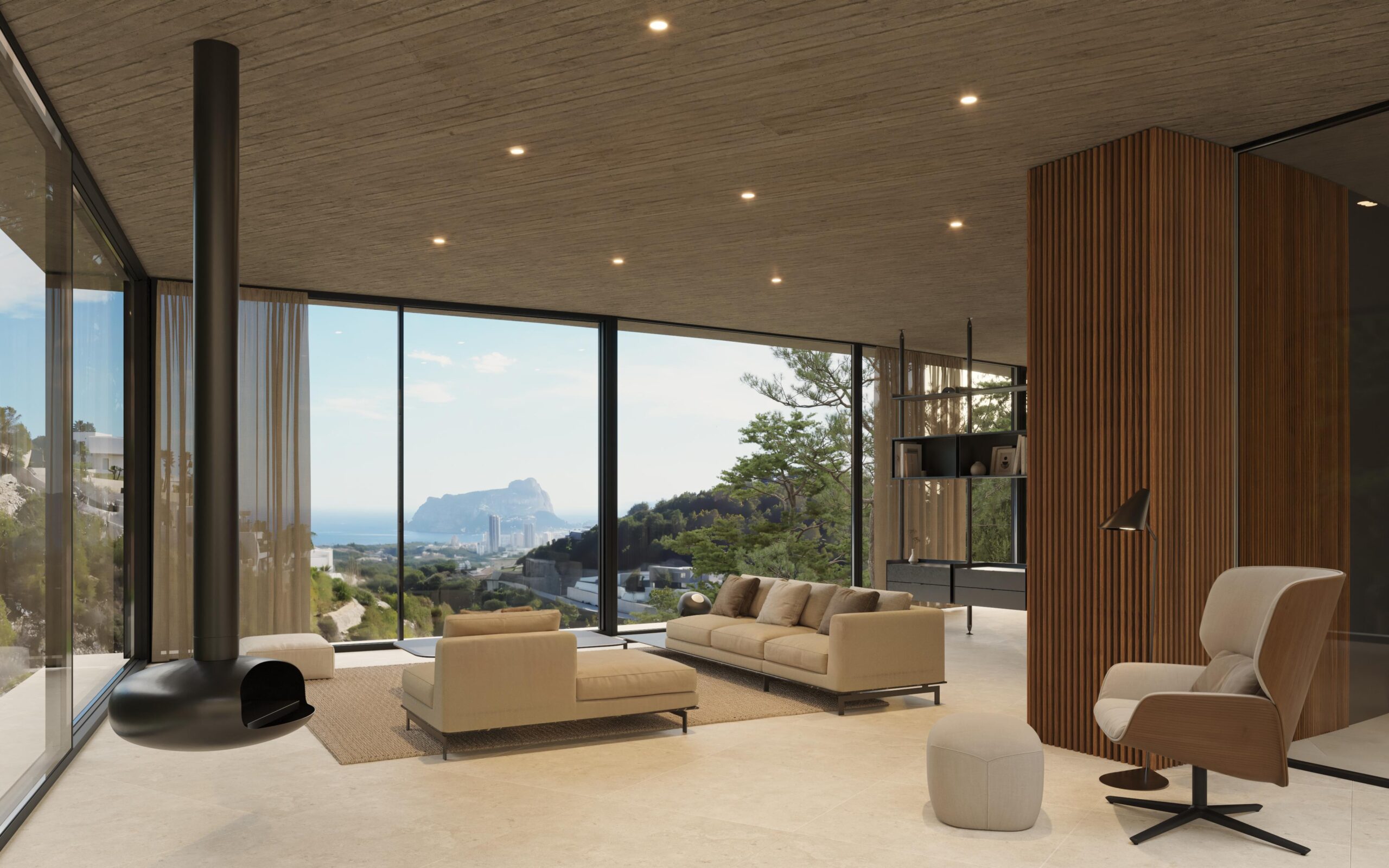 Moderner Wohnbereich mit hängendem Kamin, Betondecken und bodentiefen Fenstern mit Panoramablick auf die Mittelmeerküste und den Peñón de Ifach.