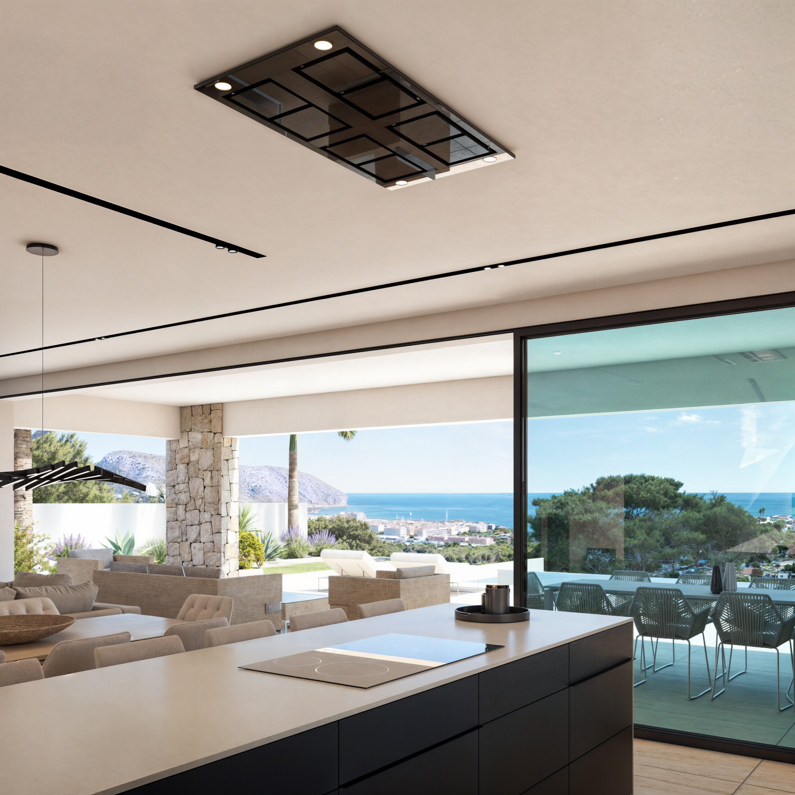 Moderne Kücheninsel mit Induktionsfeld und Deckenhaube, angrenzend an den Wohnbereich mit Glasfront und weitem Blick auf das Meer.